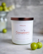 Load image into Gallery viewer, A sophisticated white jar candle from Infusion Candle Co., labeled 'Gooseberry' featuring scents of red currant, lemon peel, and geranium. The candle sits elegantly on a smooth surface with fresh green gooseberries nearby, highlighting the natural ingredients. This soy wax candle, handmade in Illinois, offers a refreshing and zesty aroma perfect for creating a vibrant atmosphere. Gooseberry candle by Infusion Candle Co.