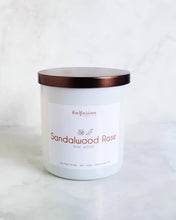 Load image into Gallery viewer, A sleek white jar candle from Infusion Candle Co., labeled 'Sandalwood Rose' with a sophisticated blend of rose and woody sandalwood scents. The candle is set against a clean, minimalist background, emphasizing its elegant design and premium quality. This soy wax candle, handmade in Illinois, exudes a calming floral and earthy aroma, perfect for creating a serene and relaxing atmosphere. Sandalwood Rose candle by Infusion Candle Co.