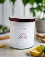 Load image into Gallery viewer, A pristine white jar candle from Infusion Candle Co., labeled 'Spice' with enticing scents of lemon, ginger, and saffron. The candle is displayed alongside fresh lemon slices and ginger roots, accentuating its warm and zesty fragrance. This soy wax candle, handmade in Illinois, creates a cozy and invigorating ambiance with its unique blend of spices. Spice candle by Infusion Candle Co.